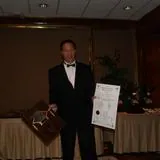 samuel kwok holding his awards