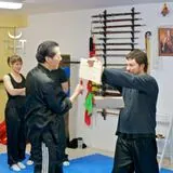 sam kwok breaks board at kung fu school